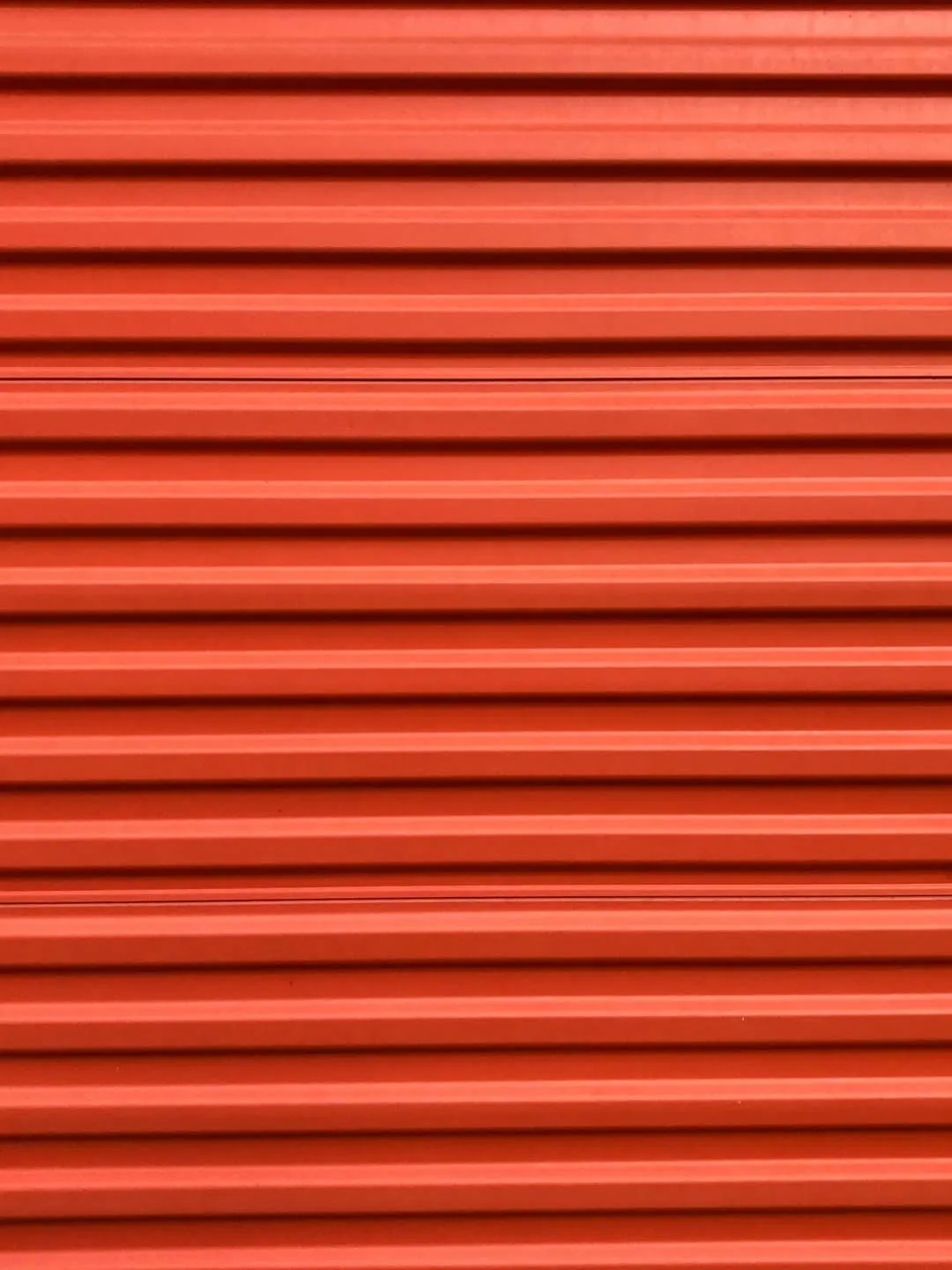 Orange self-storage unit door — closed